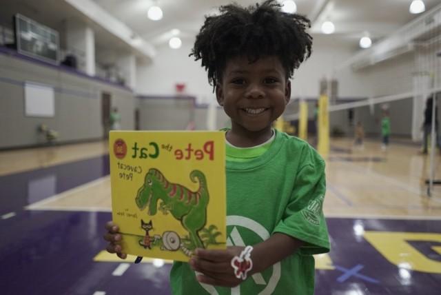 little boy holding a book